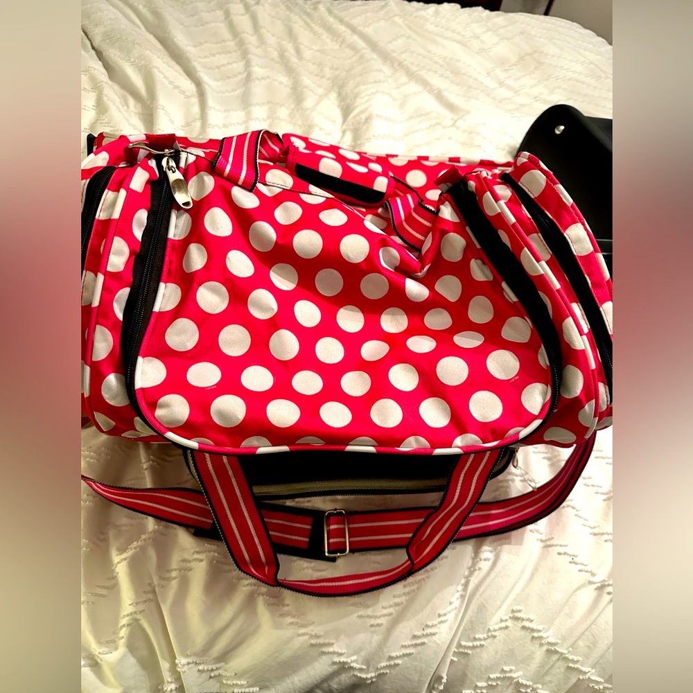 Pink and white polka dot duffle bag with wheels